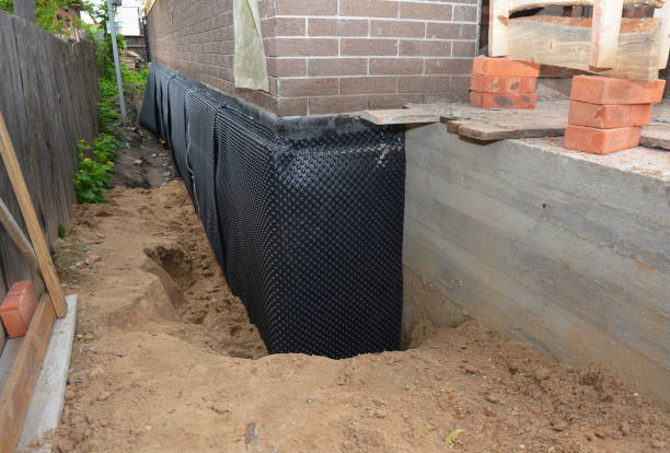 SJ Waterproofing Pros technician performing targeted Waterproofing assessment in Ludlow Falls, OH